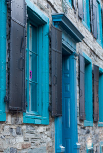 Forged metal shutters on stone building