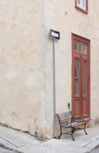 Quebec City street corner with bench, doorway, and arrow