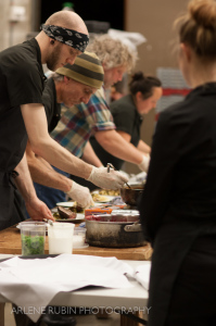 Kitchen workers in assembly line, Tom Douglas Catering