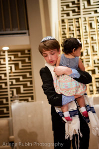 Bar Mitzvah photo - boy carrying child in synagogue