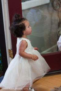 Baby girl dressed up in doorway